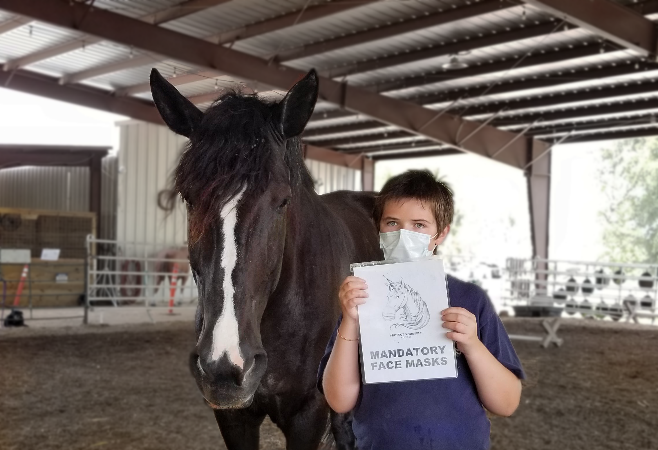 HHR Student holding sign stating face mask required.